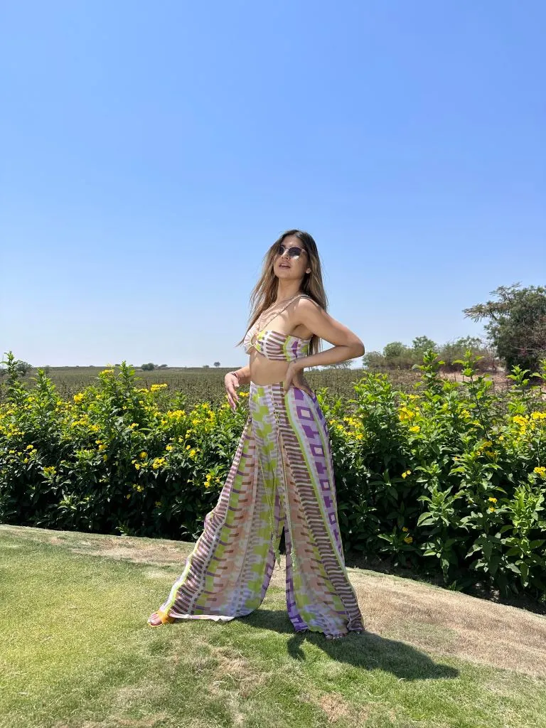 Deepika Ghose Geometric Printed Bralet with Hand Embroidered Straps and Center Ring detailing and Geometric Printed Flared Pants with Rivet Detailing from Magical Wilderness Collection