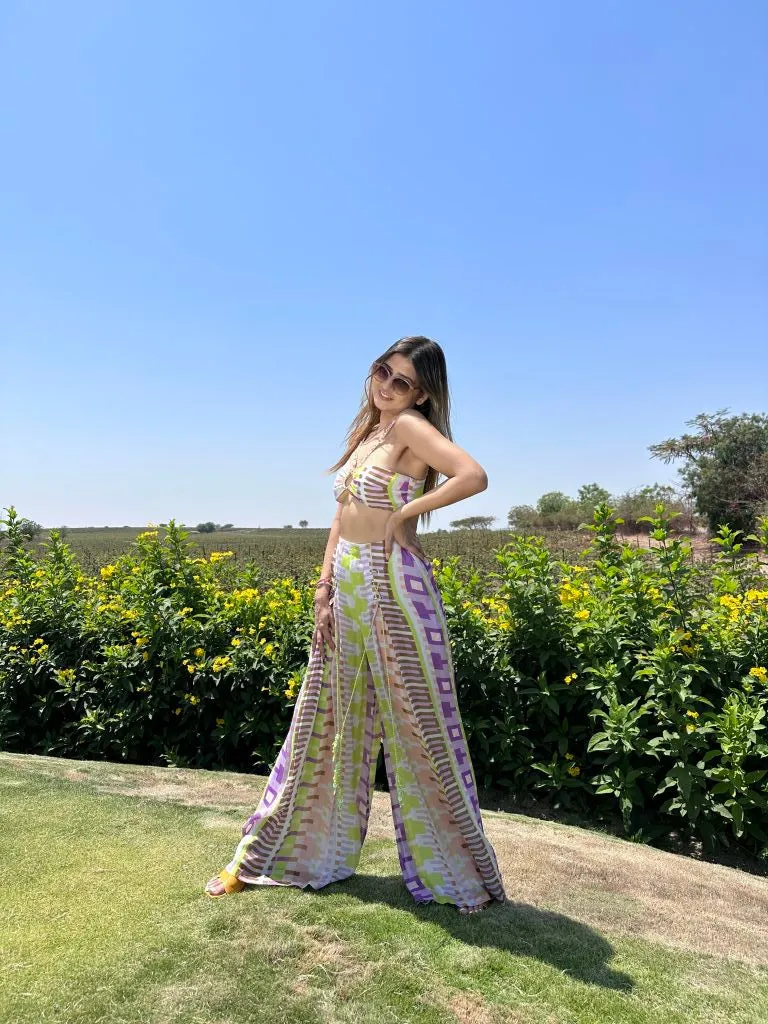 Deepika Ghose Geometric Printed Bralet with Hand Embroidered Straps and Center Ring detailing and Geometric Printed Flared Pants with Rivet Detailing from Magical Wilderness Collection